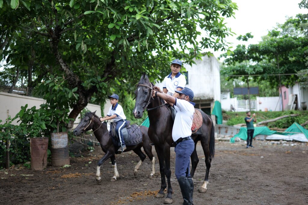 horse riding trainer guiding beginner rider